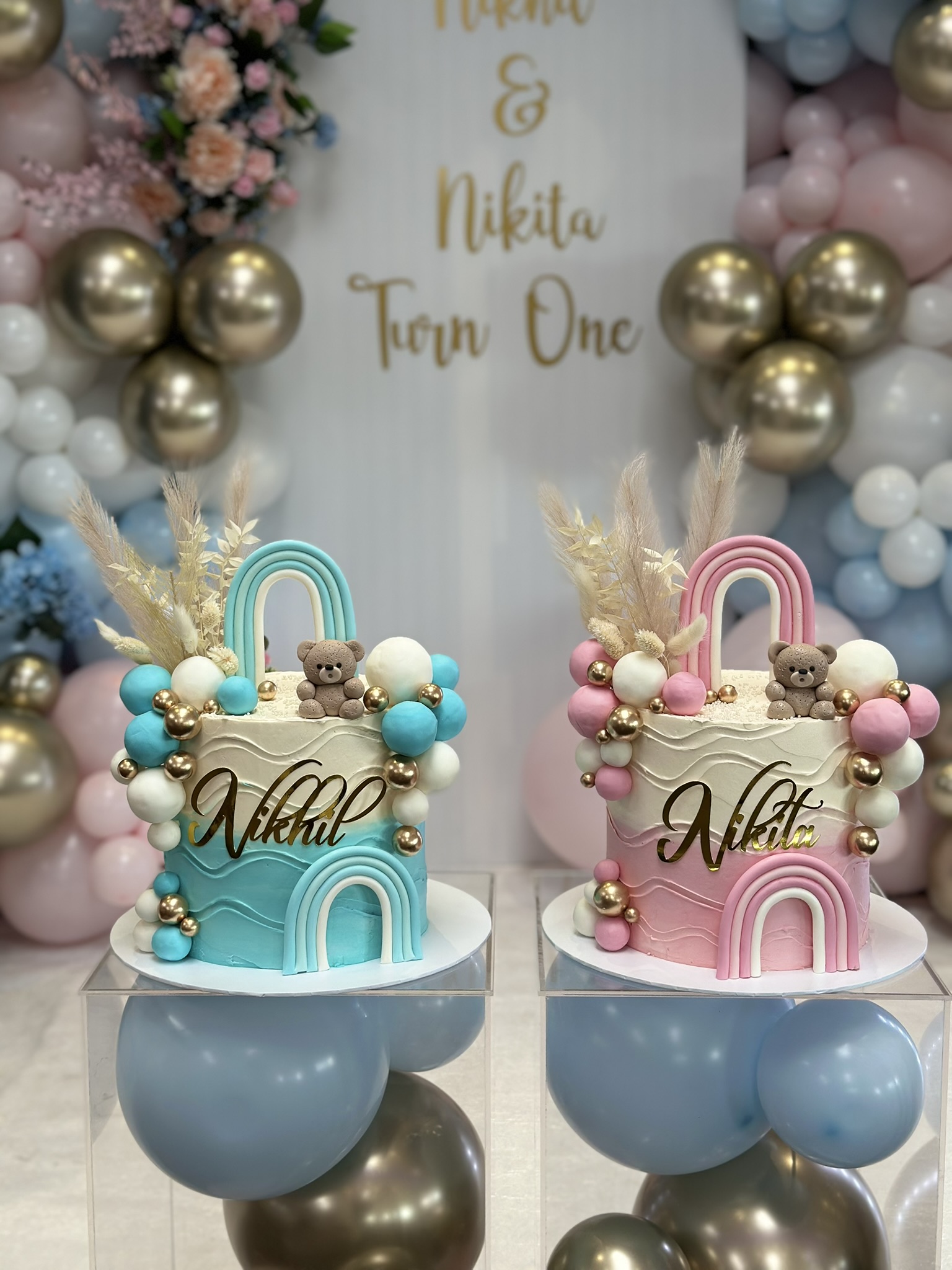 Nikhul and Nikita twin 1st birthday cakes blue and pink