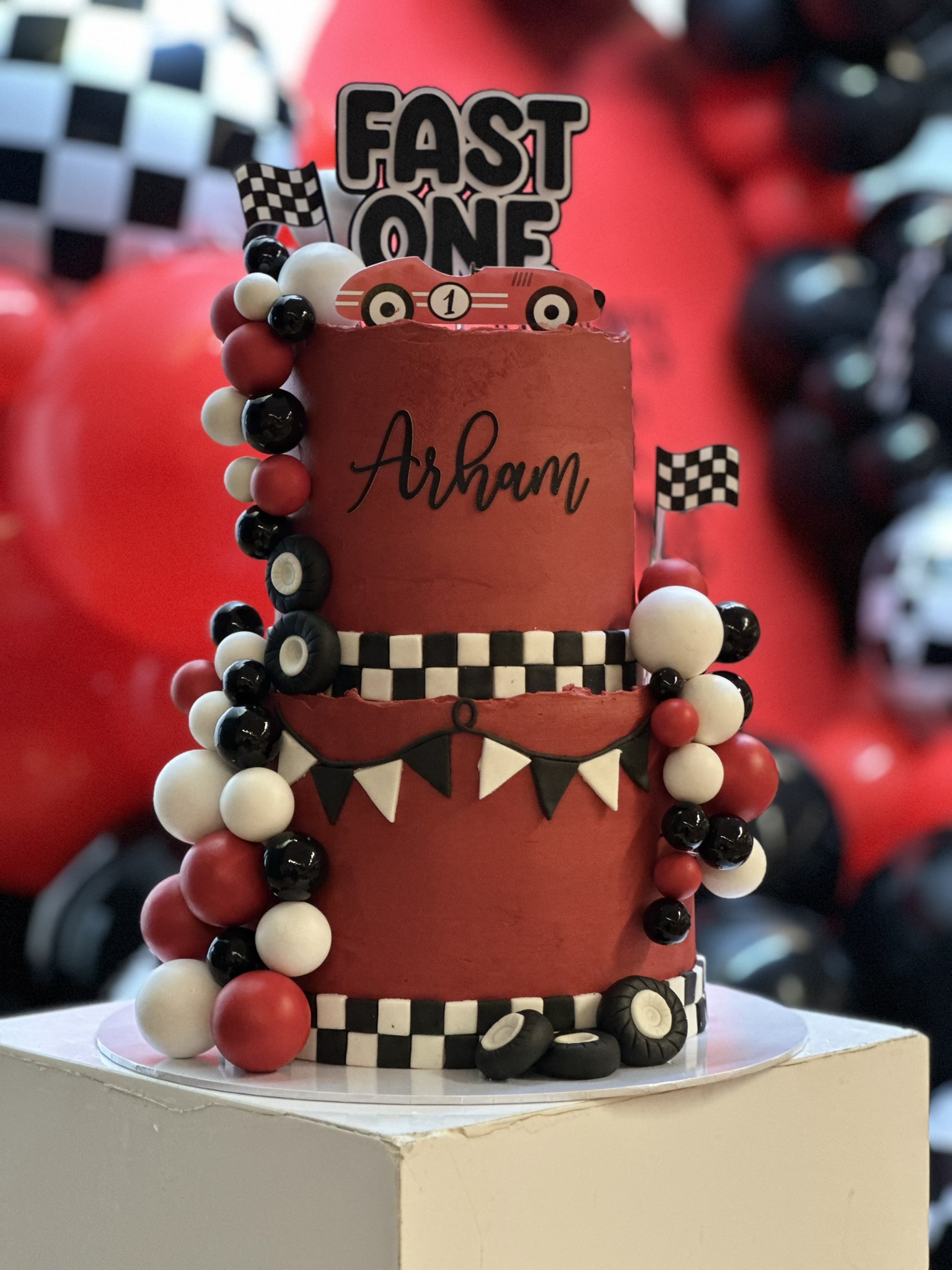 Arham Fast One racing car 1st birthday cake