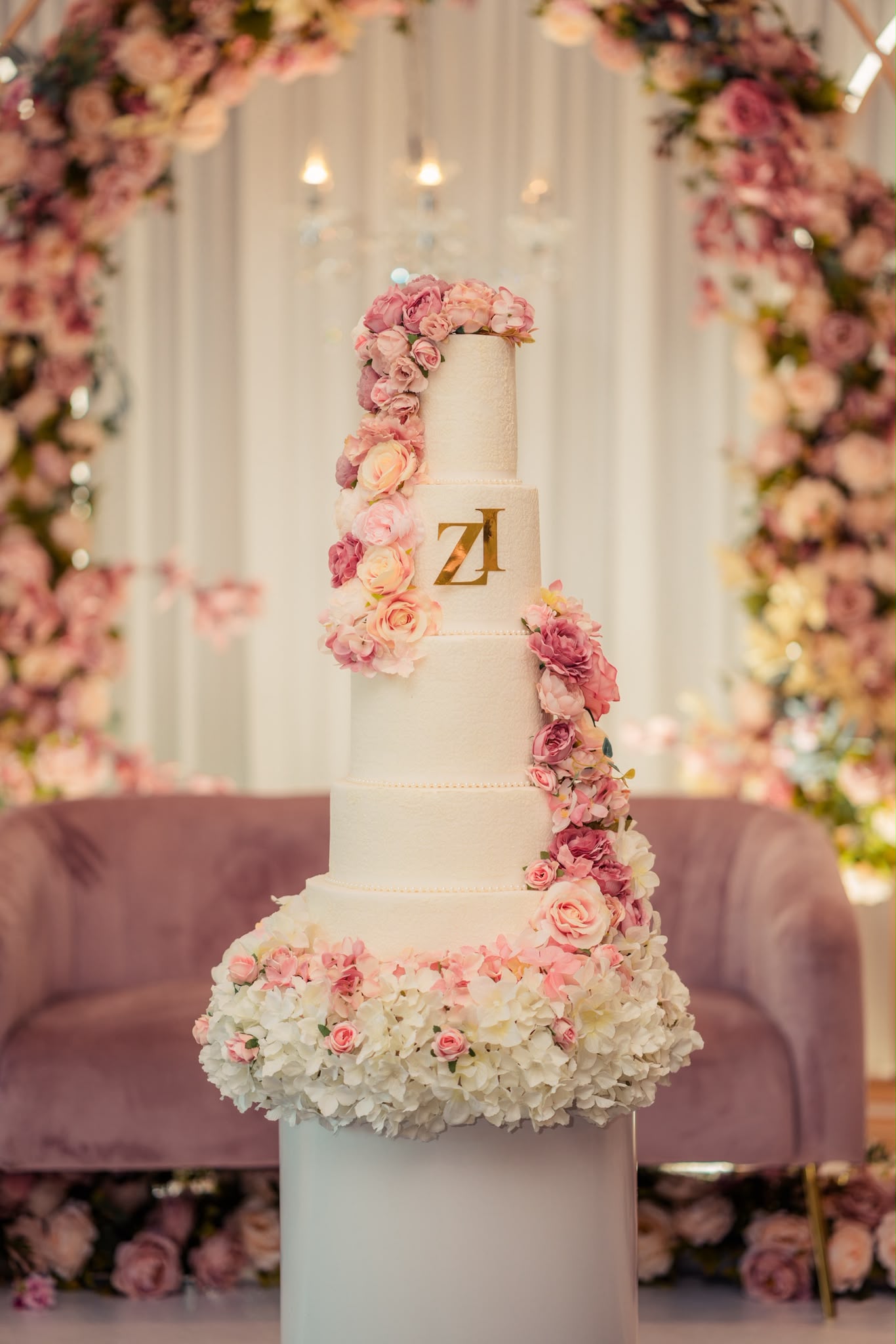 Blush and white wedding cake with flowers