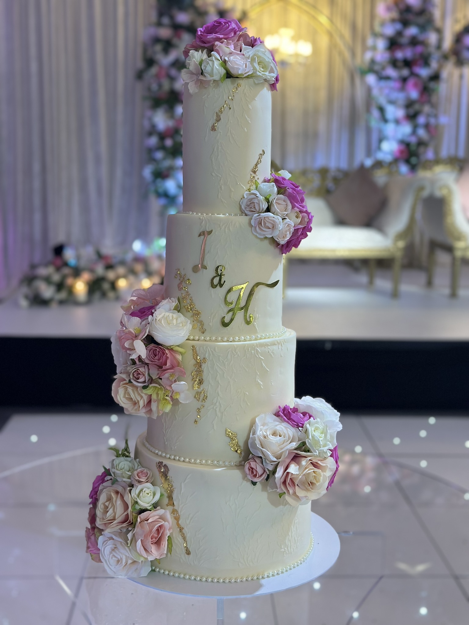 I&H 4 tier wedding cake with purple and pink roses